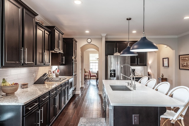 2044 Albatross Way, Gallatin, TN 37066 - kitchen featuring arched walkways, a kitchen breakfast bar, stainless steel fridge, tasteful backsplash, and ornamental molding