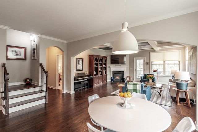 2044 Albatross Way, Gallatin, TN 37066 - dining area featuring arched walkways, wood finished floors, a warm lit fireplace, stairs, and ornamental molding