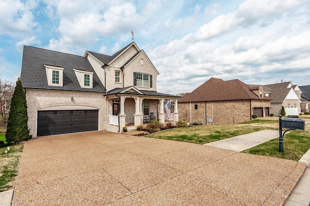 2044 Albatross Way, Gallatin, TN 37066 - view of front of property with covered porch, brick siding, driveway, a garage, and a front lawn