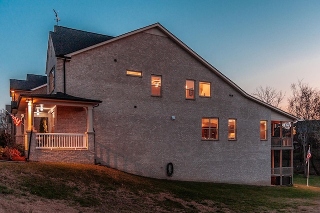 2044 Albatross Way, Gallatin, TN 37066 - property exterior at dusk featuring brick siding, a lawn, and a balcony