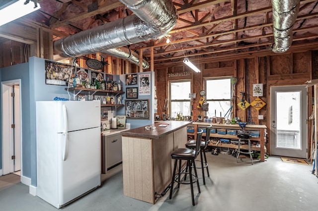 2044 Albatross Way, Gallatin, TN 37066 - kitchen with freestanding refrigerator, finished concrete flooring, a center island, open shelves, and dark countertops