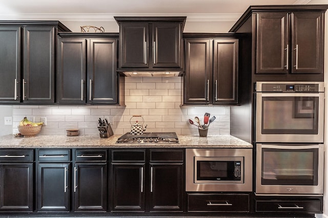 2044 Albatross Way, Gallatin, TN 37066 - kitchen with appliances with stainless steel finishes, light stone counters, decorative backsplash, and ornamental molding