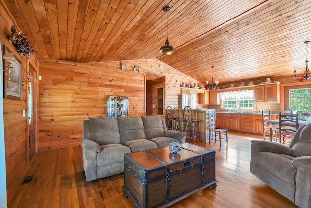 1010 Scott Rd, Bethpage, TN 37022 - living room featuring wood ceiling, vaulted ceiling, wood walls, wood finished floors, and a chandelier