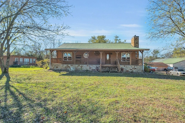 1010 Scott Rd, Bethpage, TN 37022 - log-style house featuring a porch, a chimney, a metal roof, and a front lawn