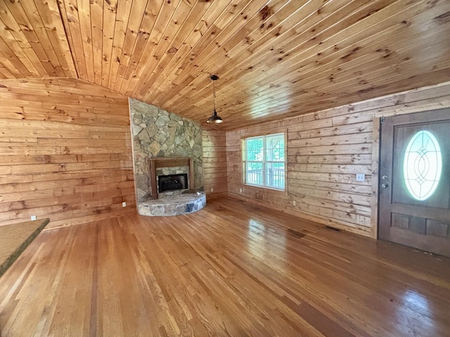 1010 Scott Rd, Bethpage, TN 37022 - unfurnished living room featuring hardwood / wood-style floors, wooden ceiling, wooden walls, a fireplace, and vaulted ceiling