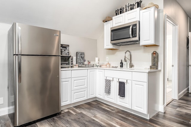3134 Friars Bridge Pass, Franklin, TN 37064 - kitchen with appliances with stainless steel finishes, dark wood finished floors, light countertops, and lofted ceiling