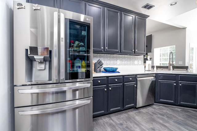 3134 Friars Bridge Pass, Franklin, TN 37064 - kitchen with stainless steel appliances, tasteful backsplash, light countertops, wood finished floors, and recessed lighting