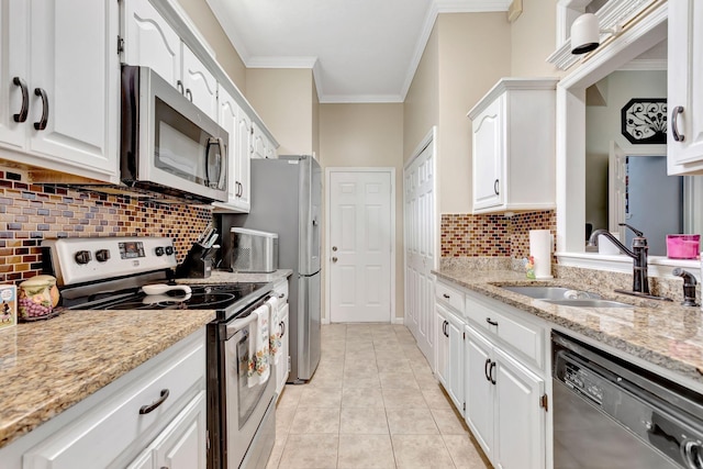 1707 University Dr, Columbia, TN 38401 - kitchen featuring stainless steel appliances, crown molding, white cabinetry, decorative backsplash, and light stone counters