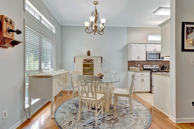 1707 University Dr, Columbia, TN 38401 - dining area with crown molding, light wood-type flooring, plenty of natural light, and a chandelier