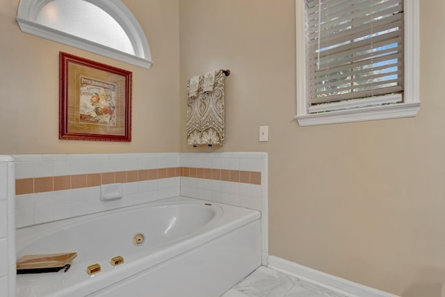 1707 University Dr, Columbia, TN 38401 - bathroom with healthy amount of natural light, a tub with jets, and marble look tiles