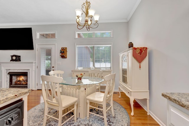 1707 University Dr, Columbia, TN 38401 - dining area featuring a chandelier, light wood-style floors, crown molding, and a fireplace