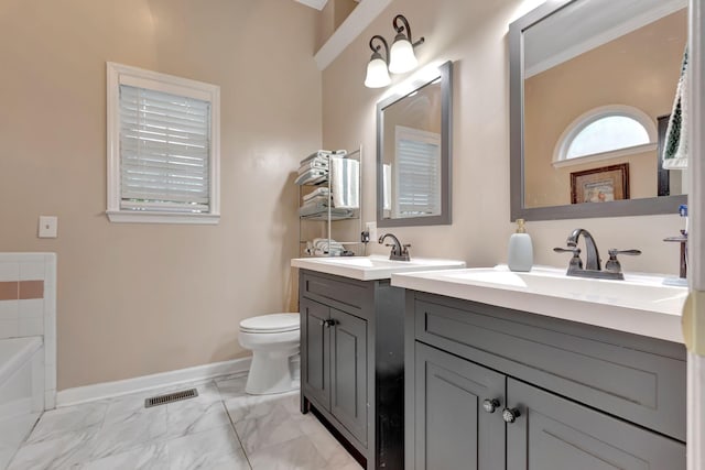 1707 University Dr, Columbia, TN 38401 - bathroom with marble finish flooring, two vanities, a tub, and crown molding