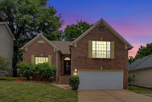 1707 University Dr, Columbia, TN 38401 - traditional-style house with an attached garage, brick siding, concrete driveway, and a lawn
