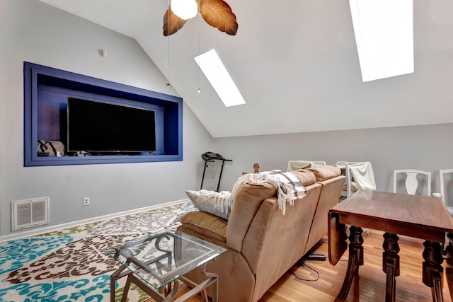 1707 University Dr, Columbia, TN 38401 - living area with a skylight, vaulted ceiling, a ceiling fan, and wood finished floors