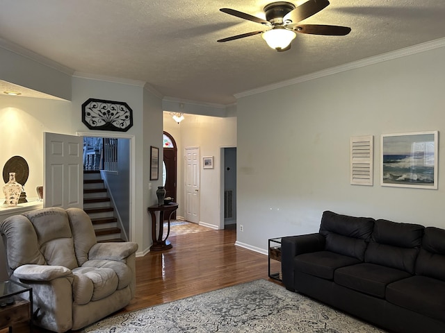1707 University Dr, Columbia, TN 38401 - living room with wood finished floors, a ceiling fan, a textured ceiling, ornamental molding, and stairway
