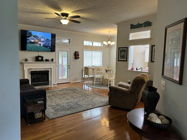 1707 University Dr, Columbia, TN 38401 - living room featuring crown molding, a chandelier, hardwood / wood-style flooring, a textured ceiling, and ceiling fan