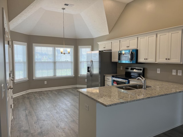 3358 Curie Cir, Christiana, TN 37037 - kitchen featuring stainless steel appliances, vaulted ceiling, light stone countertops, a chandelier, and white cabinets