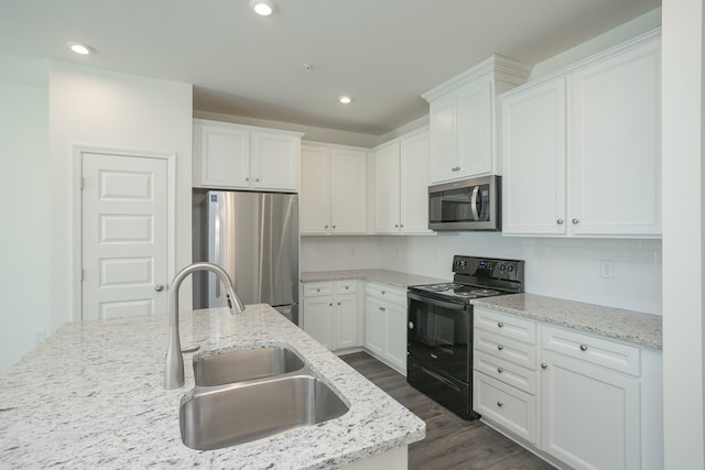 3419 Deerchase Cir, Murfreesboro, TN 37129 - kitchen with appliances with stainless steel finishes, dark wood-style flooring, white cabinetry, tasteful backsplash, and recessed lighting