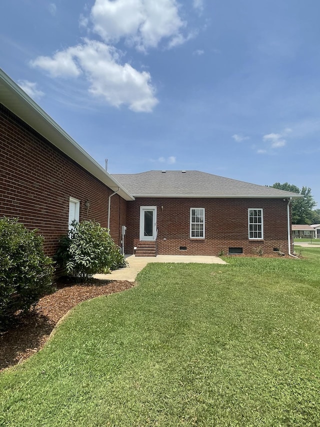 407 Robins St, Lawrenceburg, TN 38464 - back of house featuring entry steps, brick siding, and a yard
