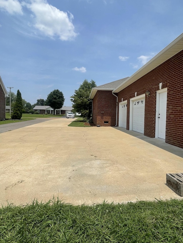 407 Robins St, Lawrenceburg, TN 38464 - view of side of home featuring brick siding and driveway