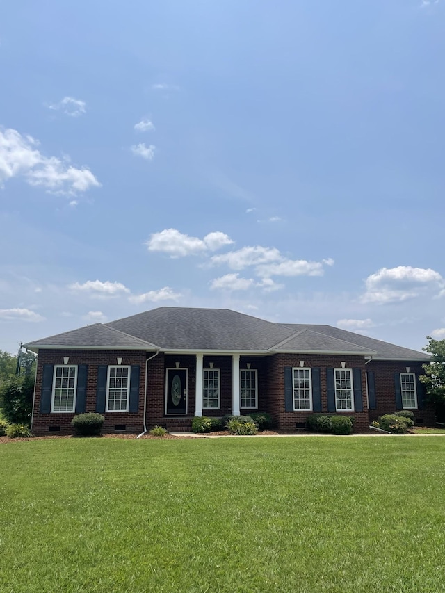 407 Robins St, Lawrenceburg, TN 38464 - ranch-style home with brick siding, a front lawn, and roof with shingles