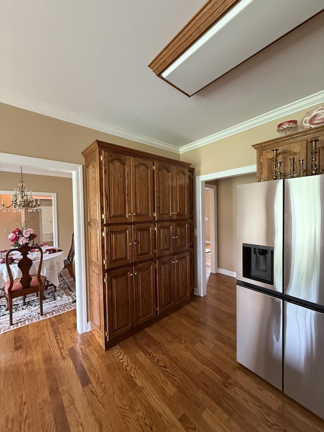 407 Robins St, Lawrenceburg, TN 38464 - kitchen featuring stainless steel fridge with ice dispenser, crown molding, wood finished floors, and a chandelier