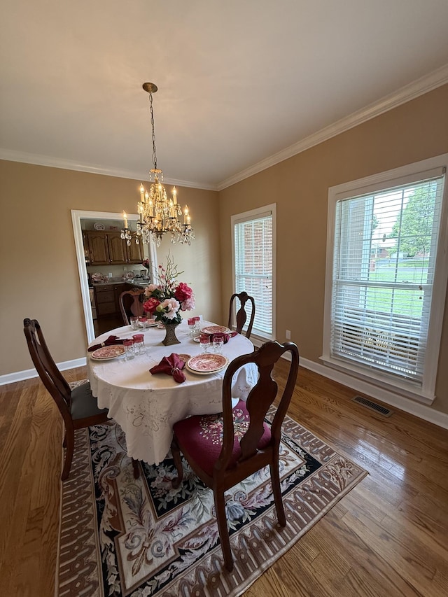 407 Robins St, Lawrenceburg, TN 38464 - dining space featuring ornamental molding, wood finished floors, and a chandelier