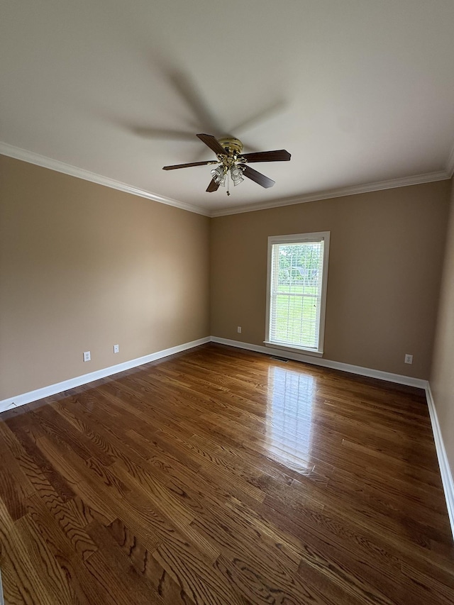 407 Robins St, Lawrenceburg, TN 38464 - unfurnished room with ornamental molding, dark wood-style flooring, and a ceiling fan