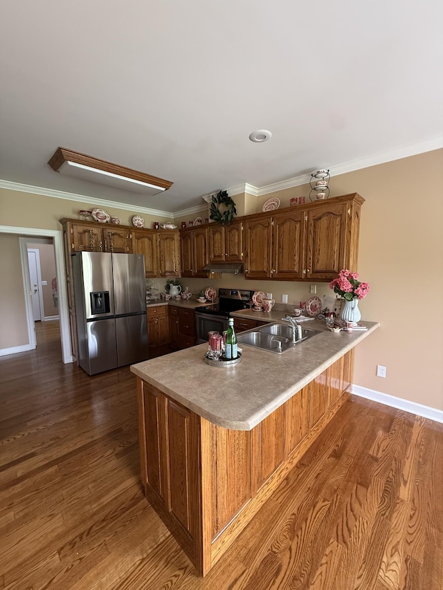 407 Robins St, Lawrenceburg, TN 38464 - kitchen featuring stainless steel appliances, a peninsula, dark wood-style flooring, crown molding, and under cabinet range hood