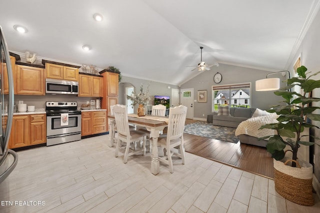 8012 Campbells Point Rd, Corryton, TN 37721 - kitchen featuring appliances with stainless steel finishes, ceiling fan, light countertops, crown molding, and lofted ceiling