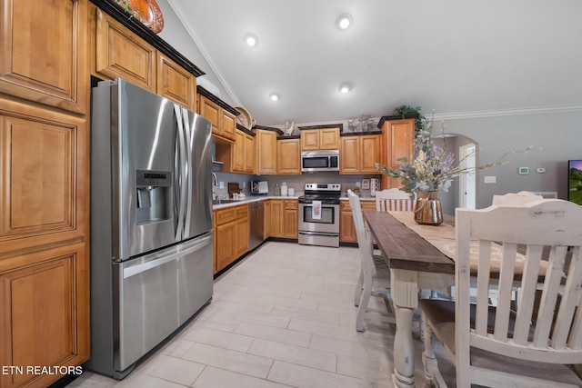 8012 Campbells Point Rd, Corryton, TN 37721 - kitchen featuring stainless steel appliances, crown molding, lofted ceiling, light countertops, and arched walkways