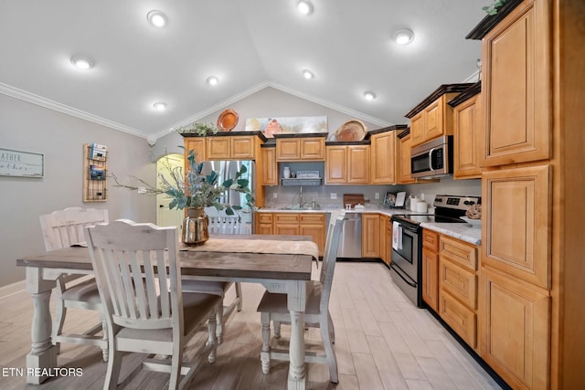 8012 Campbells Point Rd, Corryton, TN 37721 - kitchen with stainless steel appliances, vaulted ceiling, light countertops, crown molding, and light wood finished floors