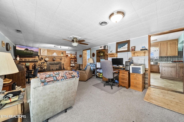 1016 Swan Pond Circle Rd, Harriman, TN 37748 - carpeted office space featuring a ceiling fan and a brick fireplace