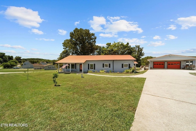 1016 Swan Pond Circle Rd, Harriman, TN 37748 - ranch-style home featuring a front yard, concrete driveway, covered porch, a metal roof, and an attached garage