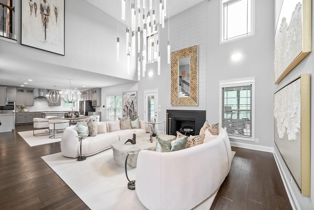 1150 Reda Dr, Clarksville, TN 37042 - living room with a towering ceiling, a fireplace, dark wood finished floors, a chandelier, and plenty of natural light