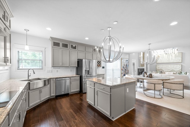 1150 Reda Dr, Clarksville, TN 37042 - kitchen featuring stainless steel appliances, gray cabinetry, a chandelier, dark wood-style flooring, and a center island
