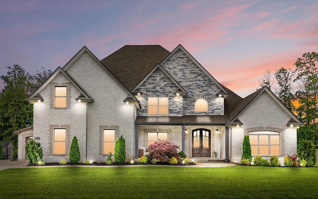 1150 Reda Dr, Clarksville, TN 37042 - french country home with a front yard, brick siding, and roof with shingles