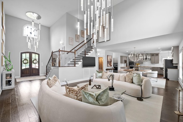 1150 Reda Dr, Clarksville, TN 37042 - living area with a chandelier, stairway, a towering ceiling, dark wood-type flooring, and french doors
