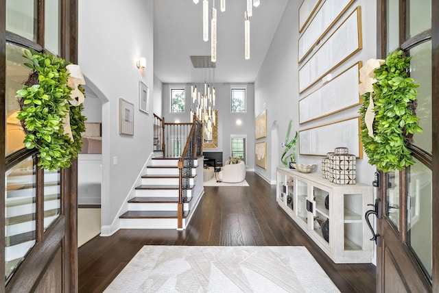 1150 Reda Dr, Clarksville, TN 37042 - foyer featuring a towering ceiling, a chandelier, stairs, hardwood / wood-style flooring, and arched walkways