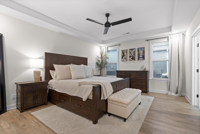 8069 Honeycomb Ln, Chattanooga, TN 37421 - bedroom with light wood-style floors, a tray ceiling, and ceiling fan