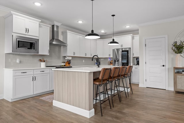 8069 Honeycomb Ln, Chattanooga, TN 37421 - kitchen featuring appliances with stainless steel finishes, wall chimney range hood, tasteful backsplash, ornamental molding, and a kitchen bar