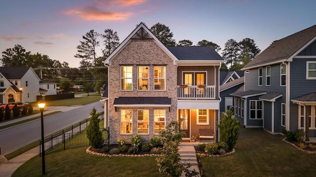 8069 Honeycomb Ln, Chattanooga, TN 37421 - back of property at dusk featuring brick siding and a balcony