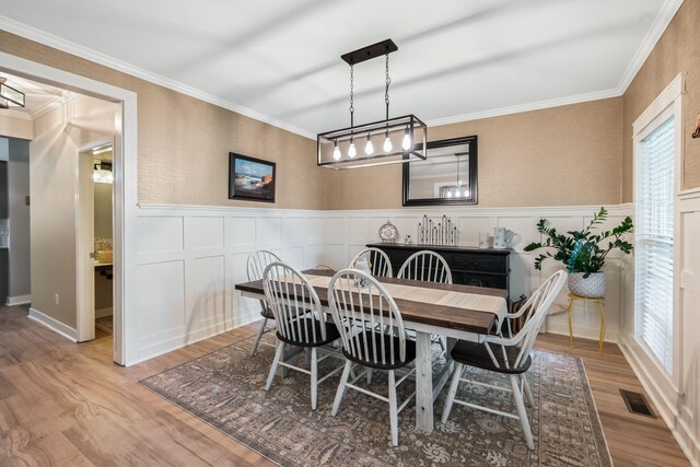 1209 Habersham Way, Franklin, TN 37067 - dining area featuring wood finished floors, a wainscoted wall, and crown molding