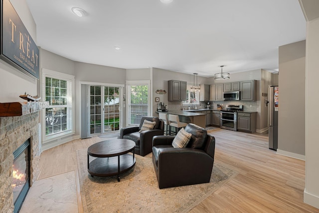 1209 Habersham Way, Franklin, TN 37067 - living room featuring plenty of natural light, light wood-style flooring, and a fireplace
