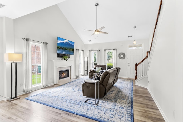 2003 Solomon Ct, Spring Hill, TN 37174 - living area with ceiling fan, high vaulted ceiling, wood finished floors, stairs, and a high end fireplace