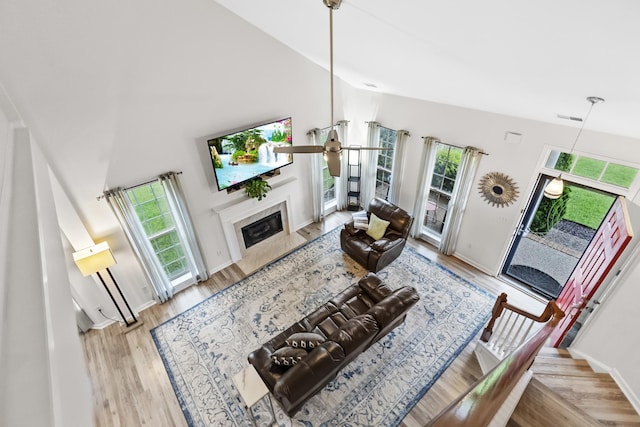 2003 Solomon Ct, Spring Hill, TN 37174 - living area featuring wood finished floors, a high end fireplace, a ceiling fan, and high vaulted ceiling
