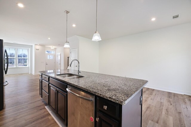 4316 Summercrest Blvd Unit 713, Antioch, TN 37013 - kitchen with stainless steel appliances, a center island with sink, light wood-style flooring, stone counters, and open floor plan