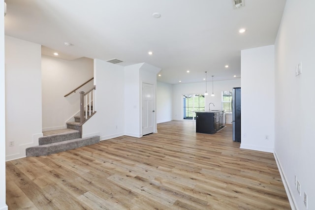 4316 Summercrest Blvd Unit 713, Antioch, TN 37013 - unfurnished living room featuring light wood finished floors, stairway, and recessed lighting