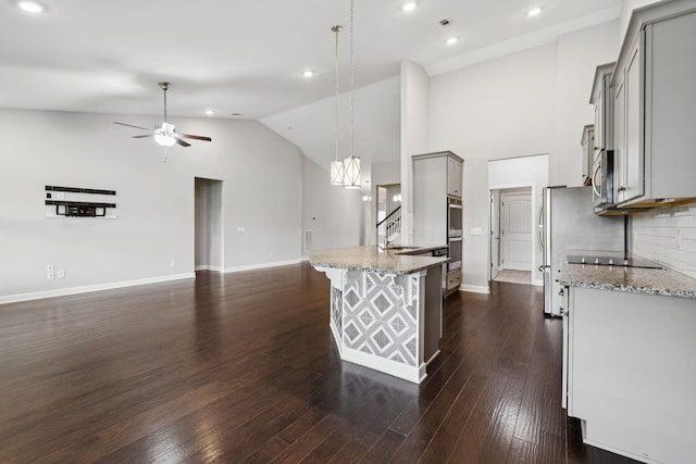 321 Twelve Oaks Ln, Lebanon, TN 37087 - kitchen with gray cabinets, ceiling fan, open floor plan, light stone countertops, and stainless steel appliances