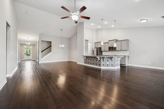 321 Twelve Oaks Ln, Lebanon, TN 37087 - unfurnished living room featuring dark wood finished floors, a ceiling fan, high vaulted ceiling, recessed lighting, and a chandelier